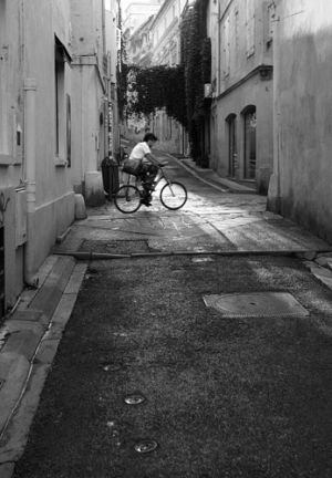 Early morning cyclist in Arles, Southern France.